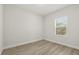 Bedroom with hardwood style floors and natural light from window at 3995 Sw 151 Street, Ocala, FL 34473