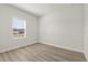 Bedroom with modern floors and natural light from window at 3995 Sw 151 Street, Ocala, FL 34473