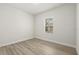 Bedroom with hardwood style floors and natural light from window at 3995 Sw 151 Street, Ocala, FL 34473