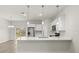 Modern kitchen with stainless steel appliances, white cabinetry, quartz counters, and a central island at 3995 Sw 151 Street, Ocala, FL 34473