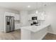 Modern kitchen showcasing stainless steel appliances, white cabinets, and an island with counter seating at 3995 Sw 151 Street, Ocala, FL 34473