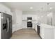 Bright kitchen with stainless steel appliances, white cabinets, and an island with a sink at 3995 Sw 151 Street, Ocala, FL 34473