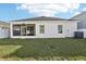 The backyard has a screened patio and a newly installed fence at 411 Lily Ln, Davenport, FL 33837