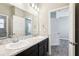 Bathroom with double sinks, a marble-look countertop, and a modern vanity at 411 Lily Ln, Davenport, FL 33837