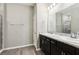 Bathroom view featuring double sink vanity and walk-in shower at 411 Lily Ln, Davenport, FL 33837