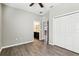 Bedroom with a ceiling fan, wood-look floors and an ensuite bathroom at 411 Lily Ln, Davenport, FL 33837