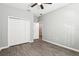 Bedroom with a ceiling fan, wood-look floors and a double closet at 411 Lily Ln, Davenport, FL 33837