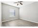 Cozy bedroom with a ceiling fan, wood-look floors and natural light from the window at 411 Lily Ln, Davenport, FL 33837