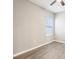 Bedroom with a ceiling fan, wood-look floors and a bright window at 411 Lily Ln, Davenport, FL 33837