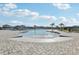 A view of the community pool with zero entry and seating all around at 411 Lily Ln, Davenport, FL 33837