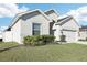 Charming single-Gathering home featuring well-maintained lawn, attached two-car garage, and classic design at 411 Lily Ln, Davenport, FL 33837
