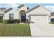 Attractive single-story home with a well-manicured lawn and inviting front facade at 411 Lily Ln, Davenport, FL 33837