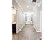 The hallway leads to the front door, it has hardwood floors and a half bathroom on the left at 411 Lily Ln, Davenport, FL 33837