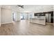 Open-concept kitchen featuring stainless steel appliances, dark cabinets, and a granite breakfast bar at 411 Lily Ln, Davenport, FL 33837