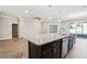 Granite-topped island with stainless steel appliances and view to the backyard at 411 Lily Ln, Davenport, FL 33837