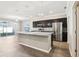 Modern kitchen featuring stainless steel appliances, granite countertops and a large kitchen island at 411 Lily Ln, Davenport, FL 33837