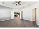 An open concept living room with views to the kitchen, and wood floors at 411 Lily Ln, Davenport, FL 33837