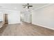 Large open living space featuring modern wood flooring and a neutral paint palette at 411 Lily Ln, Davenport, FL 33837