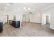 Expansive open-concept living space featuring wood-look floors, recessed lighting, and seamless flow to the kitchen at 411 Lily Ln, Davenport, FL 33837
