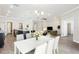 Open living space with kitchen, dining, and living room areas creating seamless flow for modern living at 411 Lily Ln, Davenport, FL 33837