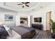 Spacious main bedroom with a tray ceiling, ceiling fan, and neutral color palette at 411 Lily Ln, Davenport, FL 33837