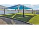 Beautiful community park area with green space, shaded seating, and walking paths for outdoor recreation and relaxation at 411 Lily Ln, Davenport, FL 33837