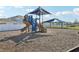 Fun-filled community playground with slides, climbing structures, and shaded areas for to enjoy outdoor activities at 411 Lily Ln, Davenport, FL 33837
