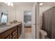 Bathroom features a granite double vanity with doorway view to the bedroom at 4149 Lana Ave, Davenport, FL 33897