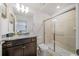 Well-lit bathroom boasts a glass-enclosed shower and granite countertop vanity at 4149 Lana Ave, Davenport, FL 33897