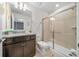 Bathroom features granite countertop vanity, toilet, and walk-in glass shower with tiled surround at 4149 Lana Ave, Davenport, FL 33897