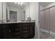 A modern bathroom with a double vanity and a separate glass-enclosed shower at 4149 Lana Ave, Davenport, FL 33897