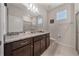 Bathroom with a glass-enclosed shower, granite counters, and neutral tile, offering a sleek and modern design at 4149 Lana Ave, Davenport, FL 33897