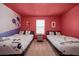 Charming bedroom featuring two twin beds with themed decor and bright red walls at 4149 Lana Ave, Davenport, FL 33897