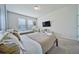 Bright bedroom featuring two cozy beds, a TV, and a large window at 4149 Lana Ave, Davenport, FL 33897