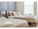 This bedroom offers two beds, a side table, and natural light from a window at 4149 Lana Ave, Davenport, FL 33897