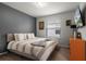 A cozy bedroom with a comfortable bed, neutral decor, and natural light from the window at 4149 Lana Ave, Davenport, FL 33897