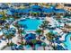 Expansive community pool featuring palm trees, ample seating and a playful lazy river at 4149 Lana Ave, Davenport, FL 33897