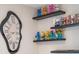 Whimsical wall decor featuring colorful figurines and a unique melting clock, adding character to the living space at 4149 Lana Ave, Davenport, FL 33897