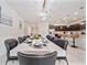 Dining area with a white table, black chairs, and view of the kitchen, ideal for Gathering gatherings at 4149 Lana Ave, Davenport, FL 33897