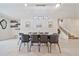 Bright dining area featuring a modern chandelier, a large table with black chairs, and elegant decor at 4149 Lana Ave, Davenport, FL 33897