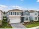 Inviting two-story home features a stone facade, lush lawn, and a charming covered entryway at 4149 Lana Ave, Davenport, FL 33897