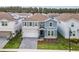 Beautiful two-story home with a stone facade, well-maintained lawn, and covered front entrance at 4149 Lana Ave, Davenport, FL 33897