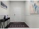 Bright foyer features neutral walls, tiled floor, console table, artwork and a decorative welcome mat at 4149 Lana Ave, Davenport, FL 33897