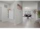 Hallway with decorative storage bench leading to a well-lit dining area and pool view at 4149 Lana Ave, Davenport, FL 33897