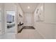 Bright hallway with tile floors, white walls, and decorative artwork at 4149 Lana Ave, Davenport, FL 33897