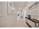 Bright, tiled hallway with decorative art leading to open-concept living spaces, enhancing the home's modern aesthetic at 4149 Lana Ave, Davenport, FL 33897