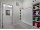 Functional mudroom area with built-in storage, neutral walls, and tiled flooring; laundry access at 4149 Lana Ave, Davenport, FL 33897