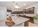 Kitchen with granite countertops, dark cabinets, stainless steel appliances, and bar stool seating at 4149 Lana Ave, Davenport, FL 33897