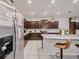 Eat-in kitchen features stainless steel appliances, granite countertops, a center island, and bar stool seating at 4149 Lana Ave, Davenport, FL 33897