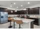 Modern kitchen featuring granite countertops, stainless steel appliances, and a breakfast bar with stools at 4149 Lana Ave, Davenport, FL 33897
